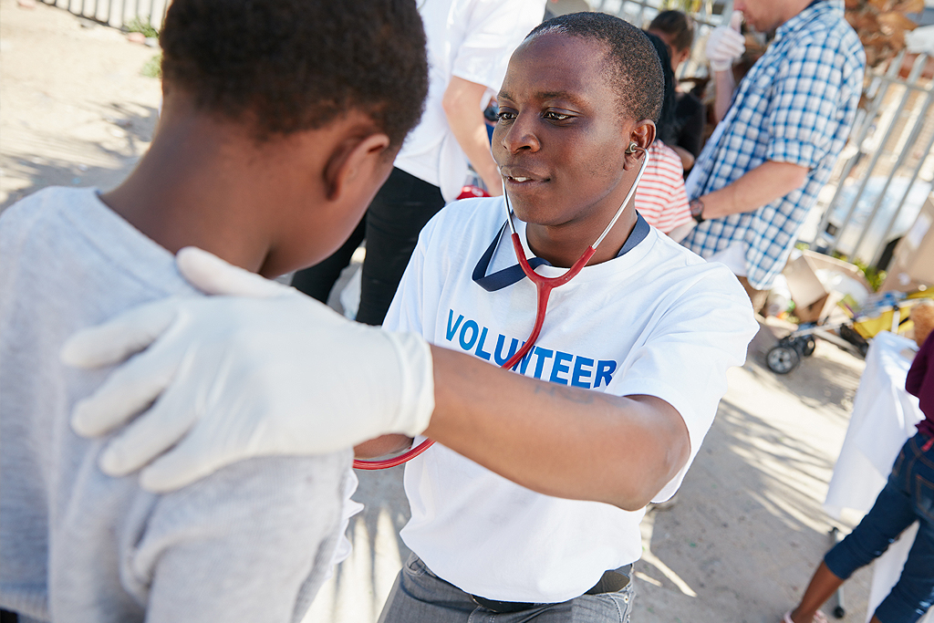 A doctor examines a young patient with a stethoscope.